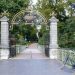 Charming ornate gate at Kronenburgerpark entrance in Nijmegen, Netherlands with a parked bicycle.